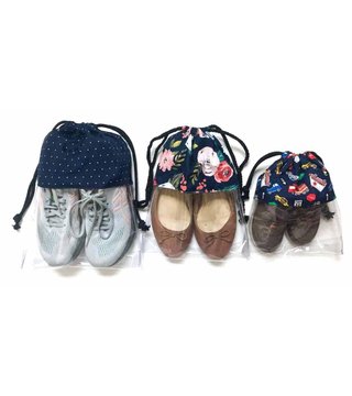 Three fabric drawstring shoe bags with clear vinyl bottoms holding trainers, ballet flats and children's shoes